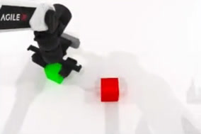 Head camera view: the robot holds a green block; a red block sits on the table.